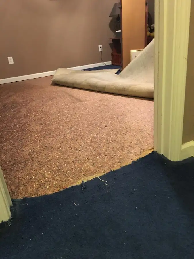 Carpet pad removal revealing water damage during Water Mitigation Services in Smiths Station